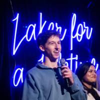 Grad smiles while speaking during Toast